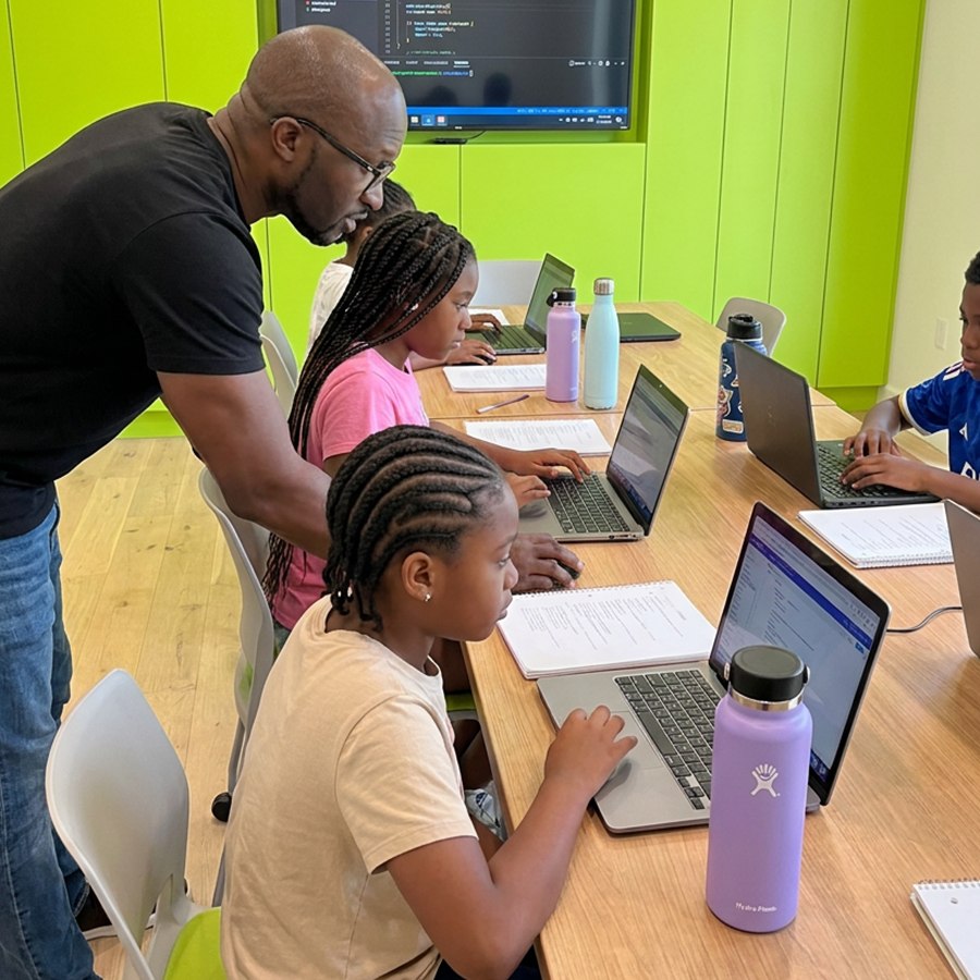 Students building AI projects around a classroom table